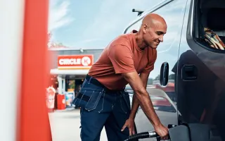 Man looking relaxed while fueling his car at a Circle K station